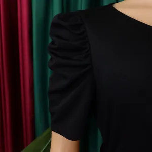 Close-up view of the elegant puff sleeve with pleated details on a stylish black summer dress