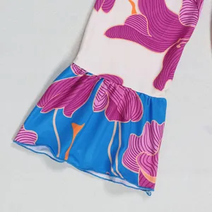 Close-up of vibrant floral print and ruffled bell sleeve on elegant mini dress