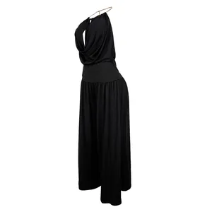 Side view of elegant black halter pleated wide-leg jumpsuit with chain detail