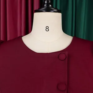Detailed macro view of burgundy high waist dress neckline with decorative buttons