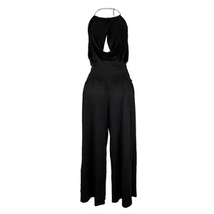 Detailed view of an elegant black halter pleated top paired with wide-leg trousers