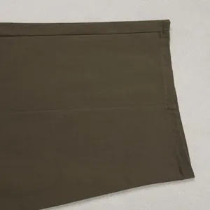 Close-up detail of the olive green casual pants hem showing high-quality stitching