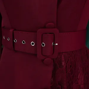 Close-up of burgundy high-waist dress featuring lace patchwork and belt detail.