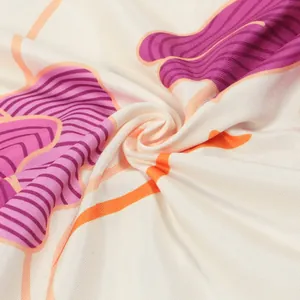 Macro view showing the soft texture and purple floral print on the dress fabric.