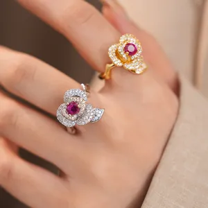 Detailed view of luxury 14k gold-plated zircon flower rings with red center stones.