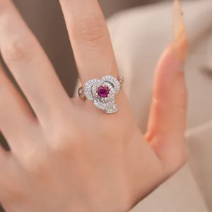 Close-up view of a rose flower ring with sparkling zircons and a red center