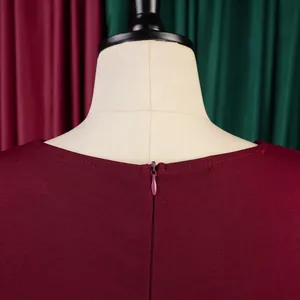 Close-up of the concealed back zipper on this elegant burgundy dress with a professional finish