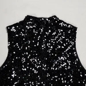 Close-up of elegant black sequined dress detail showing shimmering texture and invisible zipper