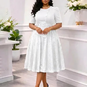 Detail view of a white mock two-piece dress with lace skirt and belted high waist.