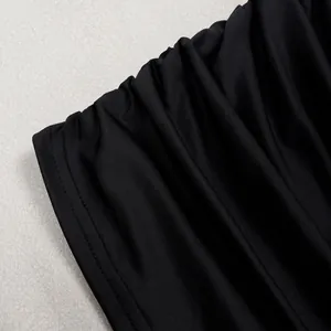 Κοντινό πλάνο του μαύρου πτυχωτού υφάσματος και της ραφής ενός κομψού στράπλες φορέματος