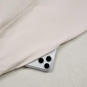 Detail view of high-quality beige commuter trousers fabric showing texture and color