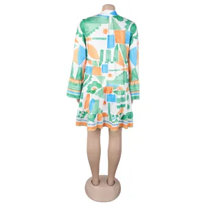 Vibrant geometric floral print V-neck tiered short dress shown from the back view