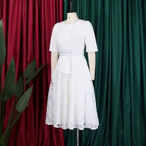 Detailed shot of a stylish white lace patchwork faux two-piece dress with high waist belt