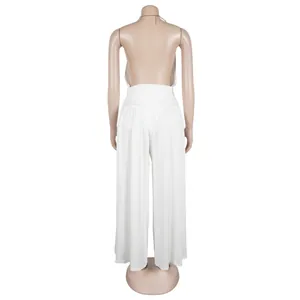 Back view of a white halter two-piece set featuring backless top and wide-leg trousers.