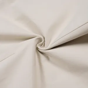 Detailed macro view of high-quality beige twill fabric for commuter casual pants