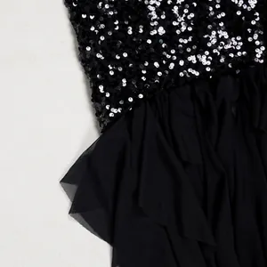 Close-up detail of the elegant black sequin and tiered mesh patchwork on a stylish party dress