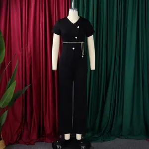 Mannequin display of a black two-piece set featuring decorative buttons and a chain belt