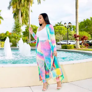 Vibrant tie-dye cardigan and pants set worn by a model in an outdoor park setting