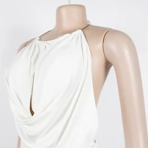 Detailed view of elegant white halter V-neck top with draped pleats for women's set
