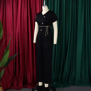 Detailed view of women's black two-piece set with button-down top and gold chain belt