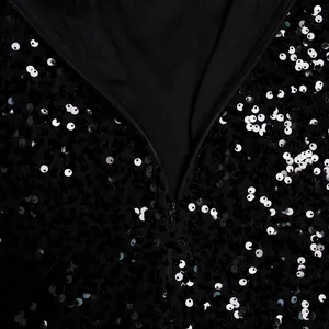 Detail view of black sequin mesh dress showing high-quality invisible zipper and texture.