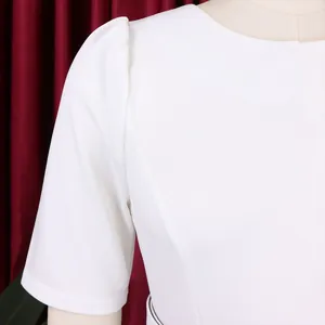Close-up of elegant white high waist dress showing round neck and puff sleeve detail