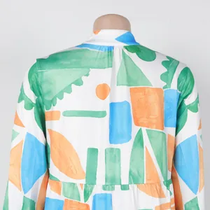 Close-up detail of the back of an elegant loose dress with vibrant geometric prints
