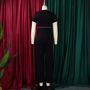 Back view of elegant black two-piece set with short sleeve top and pants on mannequin