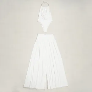 Detail view of elegant white halter neck pleated top and flowing wide-leg pants set