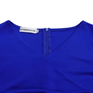 Close-up detail of blue V-neck dress showing zipper and Metamorphosis Girl label