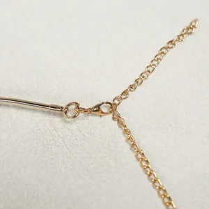 Detailed macro view of high-quality gold lobster clasp and adjustable extension chain