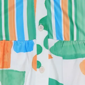 Close-up view of vibrant striped and abstract floral print fabric with button details
