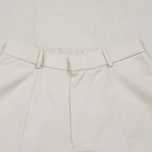 Detailed close-up view of the waistband and fabric on beige commuter casual loose trousers