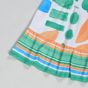 Close-up of elegant ruffled hem featuring vibrant abstract geometric prints and stripes
