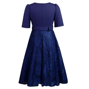 Detailed back view of an elegant navy blue dress featuring intricate lace patchwork skirt