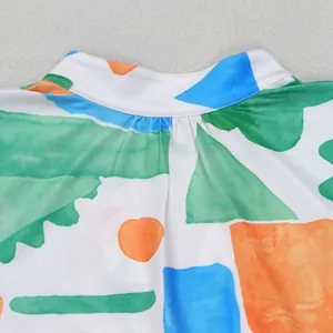 Close-up view of mock neck collar featuring colorful abstract geometric print fabric detail
