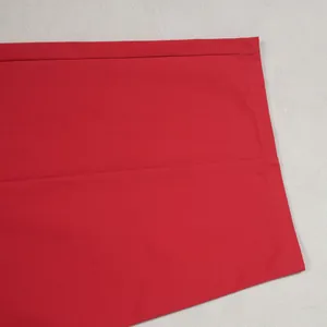 Detail view of the red casual wide-leg trousers showing premium fabric texture and hem