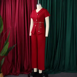 Elegant red two-piece suit with short-sleeved blazer and trousers displayed on mannequin