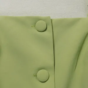 Détail en gros plan de la texture du tissu et des boutons sur combinaison verte
