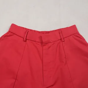 Detailed macro close-up shot of vibrant red commuter casual pants with elastic waistband texture