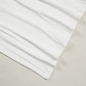 Macro view of high-quality white pleated fabric showing fine stitching and soft texture details