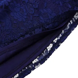 Close-up of navy blue lace patchwork dress showing intricate floral embroidery