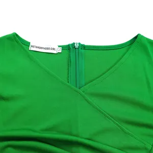 Detailed view showing the V-neckline and zipper of a stylish green summer dress