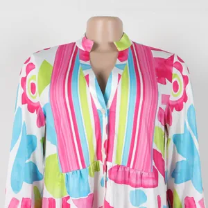 Detailed view of a vibrant floral and striped print V-neck dress with buttons