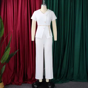Detailed view of elegant white short-sleeve top and trousers two-piece outfit set.