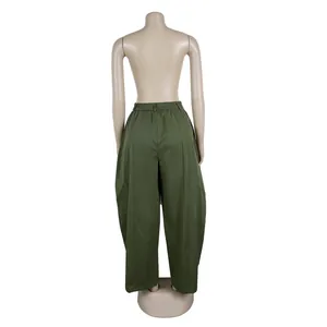 Detailed back view of olive green loose silhouette commuter casual trousers on a mannequin