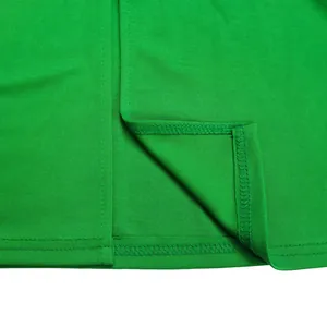 Close-up detail of green fabric with high-quality stitching on elegant maxi dress hem