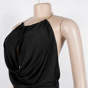 Detail of elegant black halter neck top with gold chain strap and pleated draping