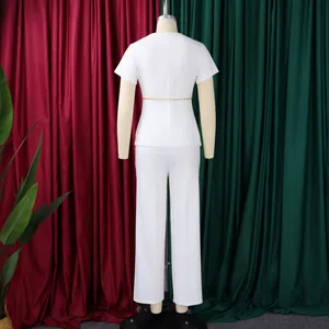 Back view of elegant white short-sleeved top and trousers two-piece set on a mannequin