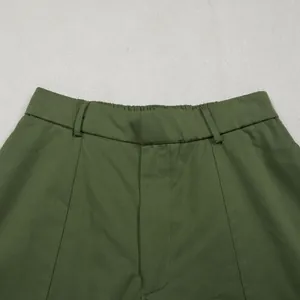 Close-up of olive green commuter casual pants showing waistband and neat stitching details